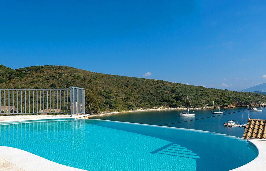 Villa Rahi infinity pool overlooking bay with sailing boats