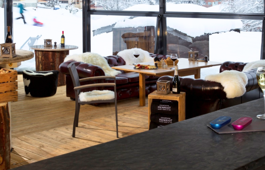 Cosy bar with sheepskin rugs on leather sofas