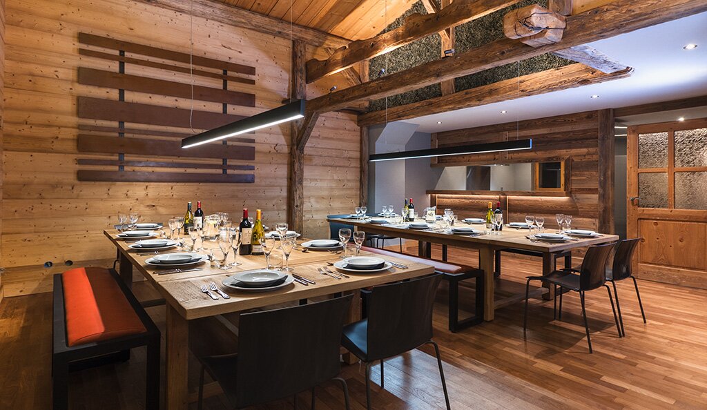 Two dining tables laid up for dinner in the chalet