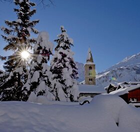 Snowy scene in Val d'Isere with church in the background 