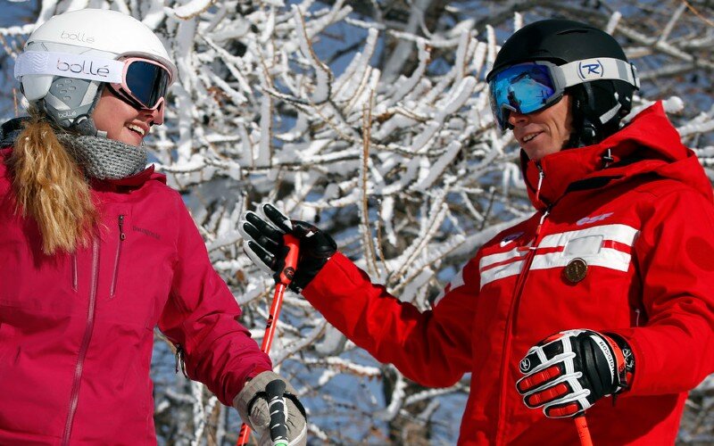 ESF ski instructor talking to female skier