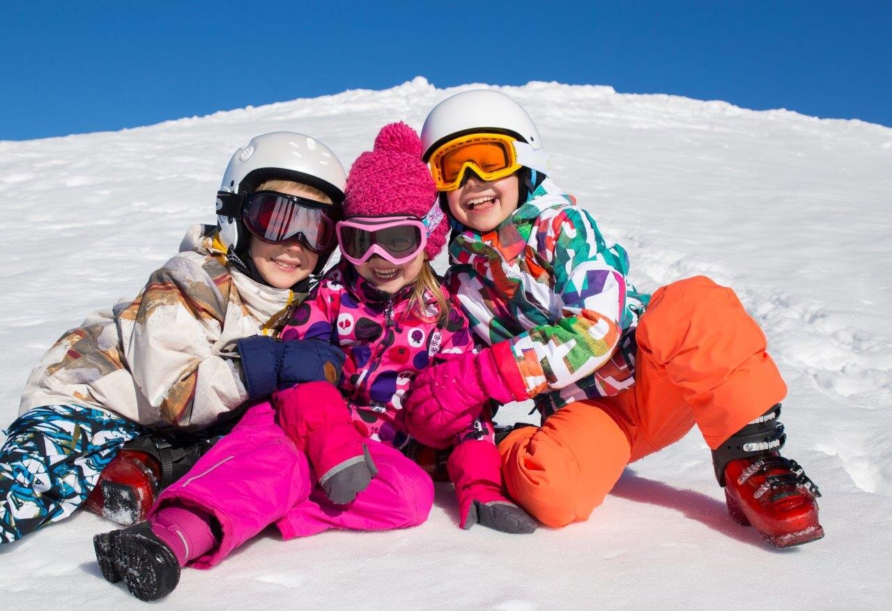 Three children on the slopes on a ski holiday
