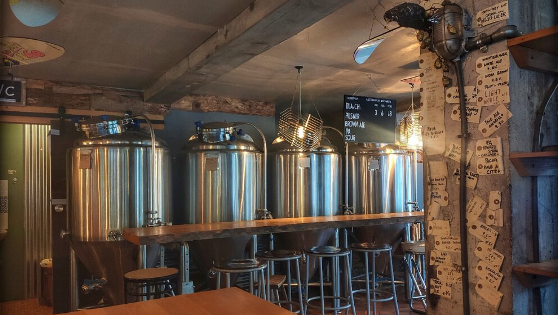 Four large beer barrels for brewing inside brewery
