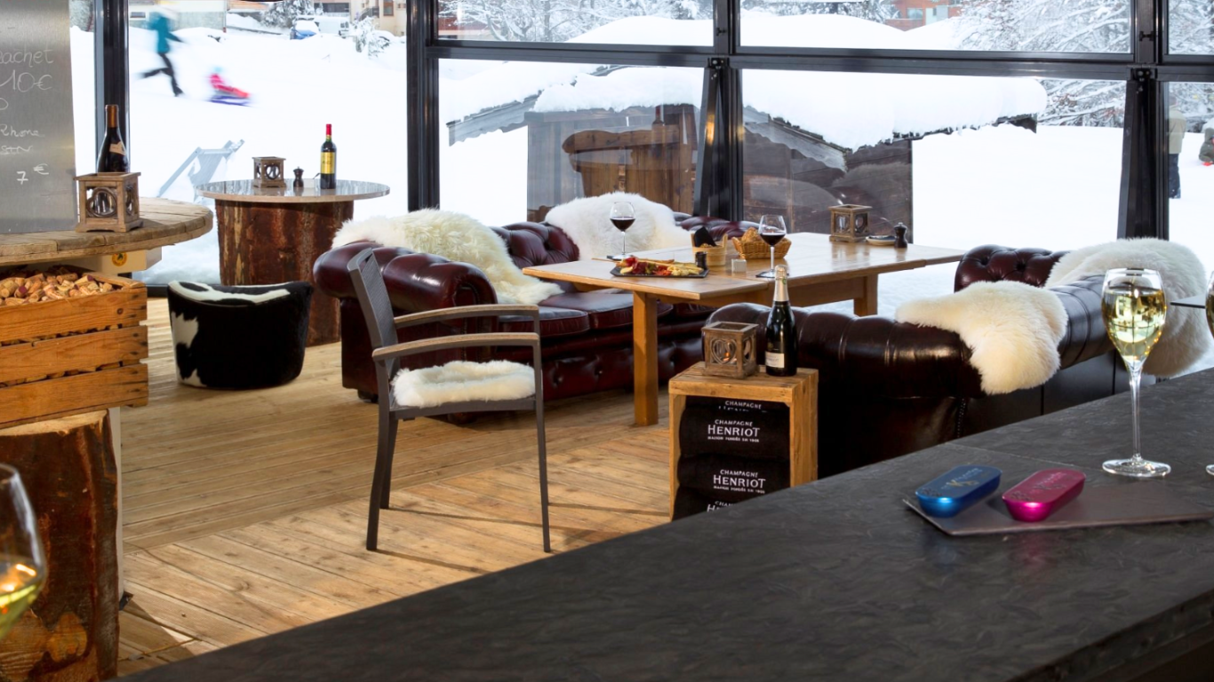 Cosy bar with sheepskin rugs on leather sofas