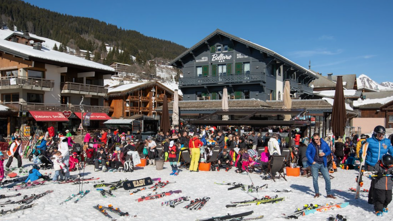 Busy terrace outside hotel in Les Gets on a sunny day