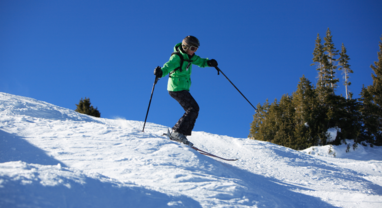 Woman skiing moguls