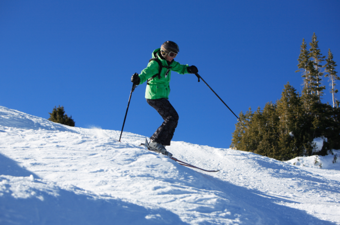 Woman skiing moguls