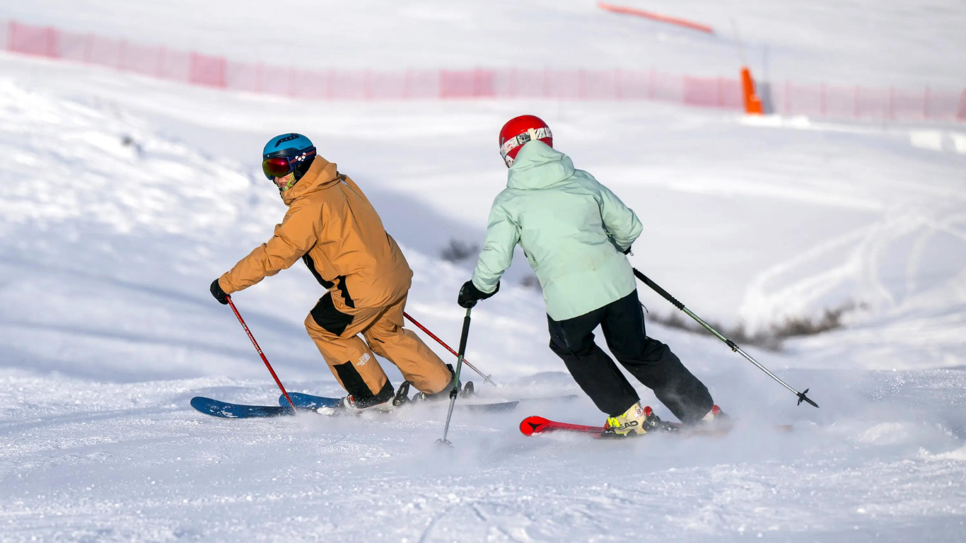 Female skier following New Generation ski instructor doing parallel turns