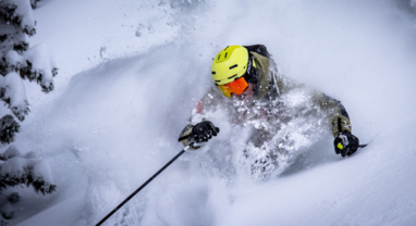 TDC Ski instructor skiing deep powder