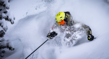 TDC Ski instructor skiing in deep powder
