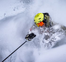 TDC Ski instructor skiing deep powder