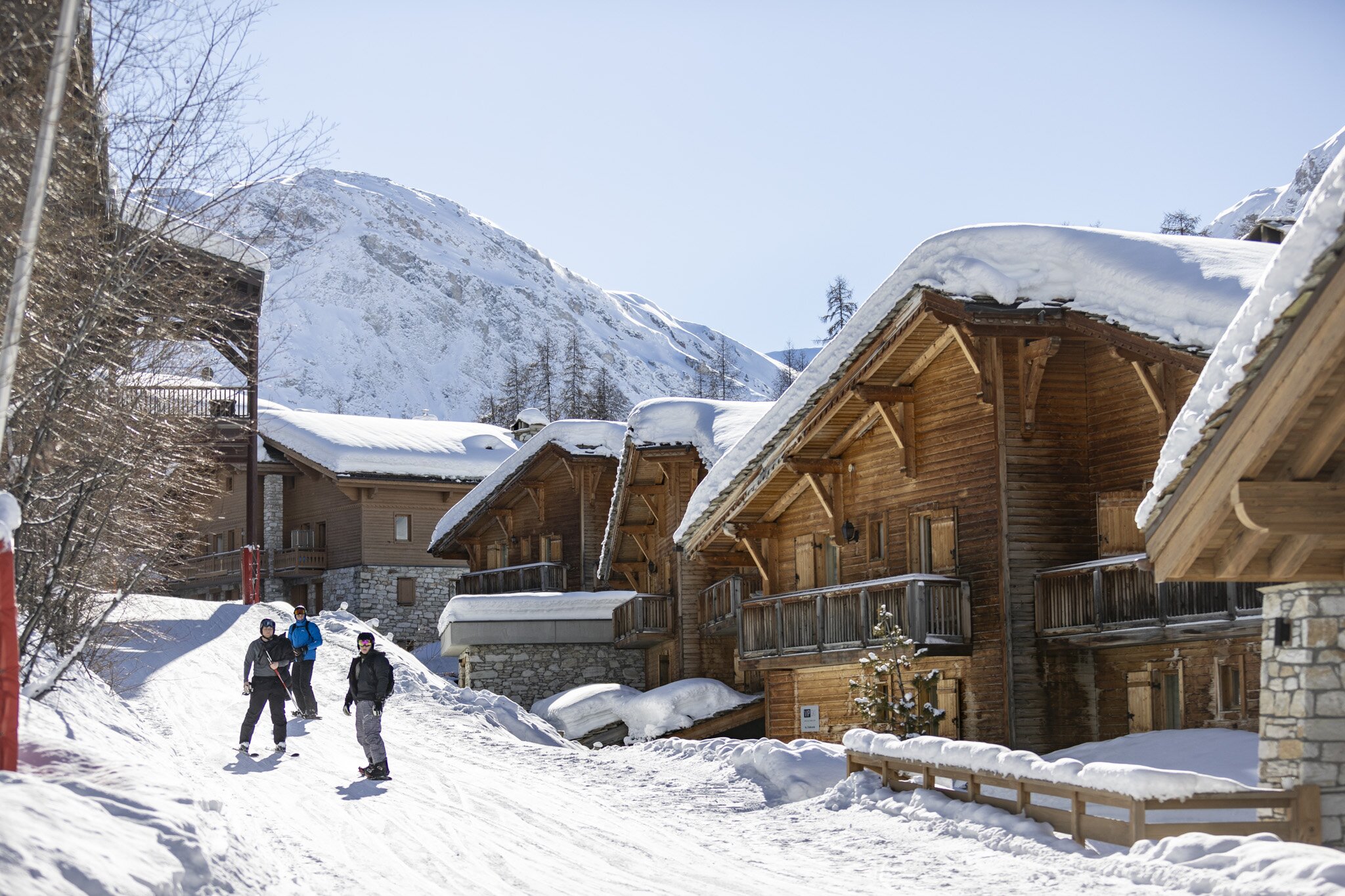 Skiers and snowboarders skiing down Santons piste in Val d'Isere