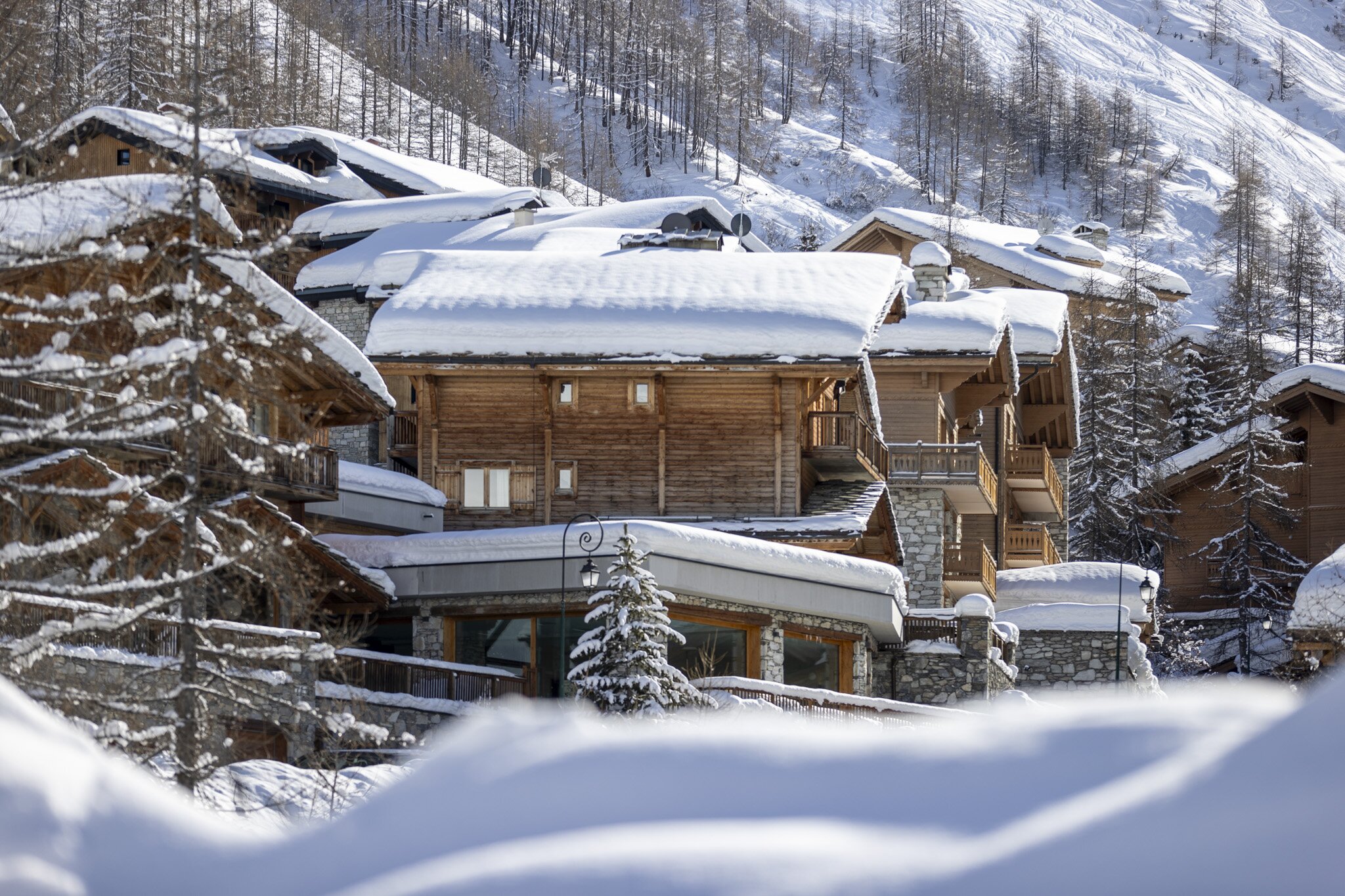 Exterior of snowy VIP SKI Bellevarde chalets in Val d'Isere on sunny day