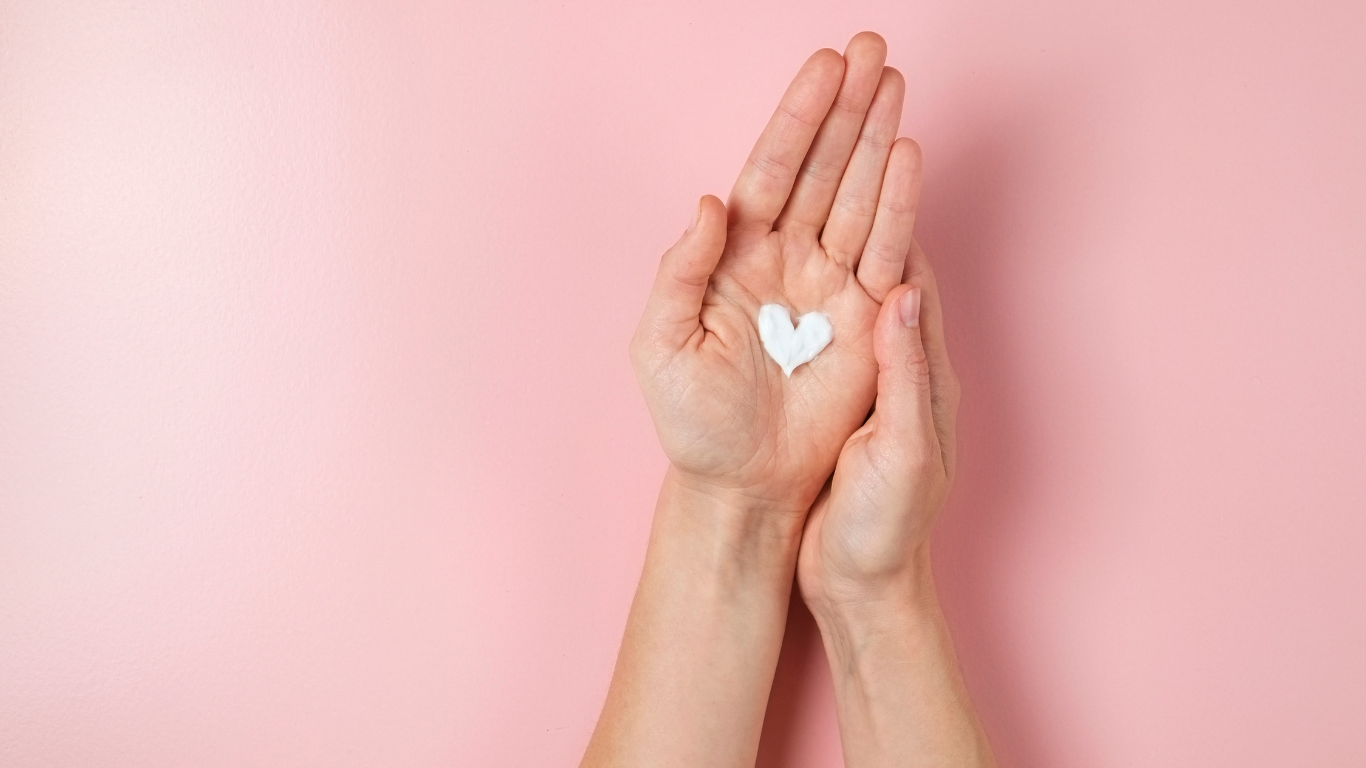 Heart-shaped dollop of hand cream in palm of hand