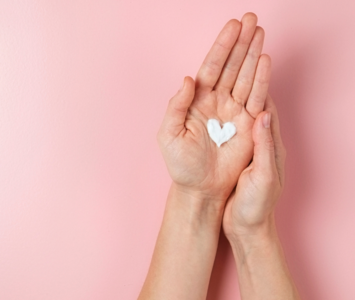 Heart-shaped dollop of hand cream in palm of hand