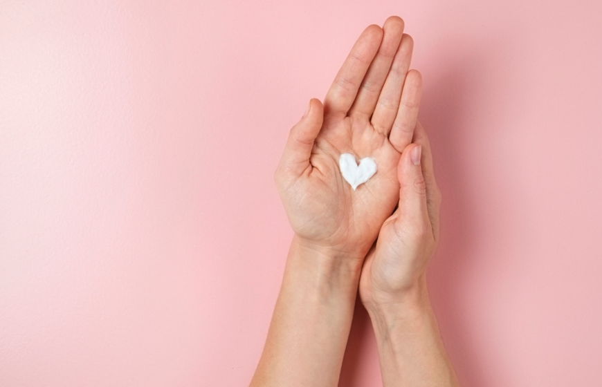 Heart-shaped dollop of hand cream in palm of hand