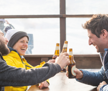 Three friends enjoying a beer after skiing