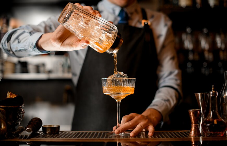Barman pouring cocktail