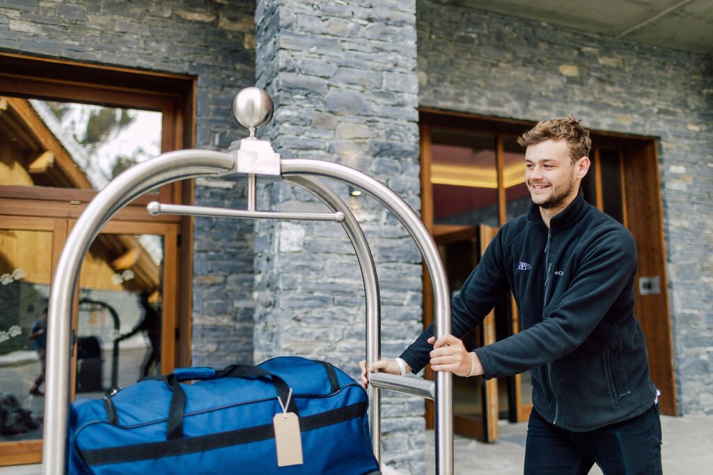 VIP SKI staff member pushing luggage trolley outside Bear Lodge ski hotel