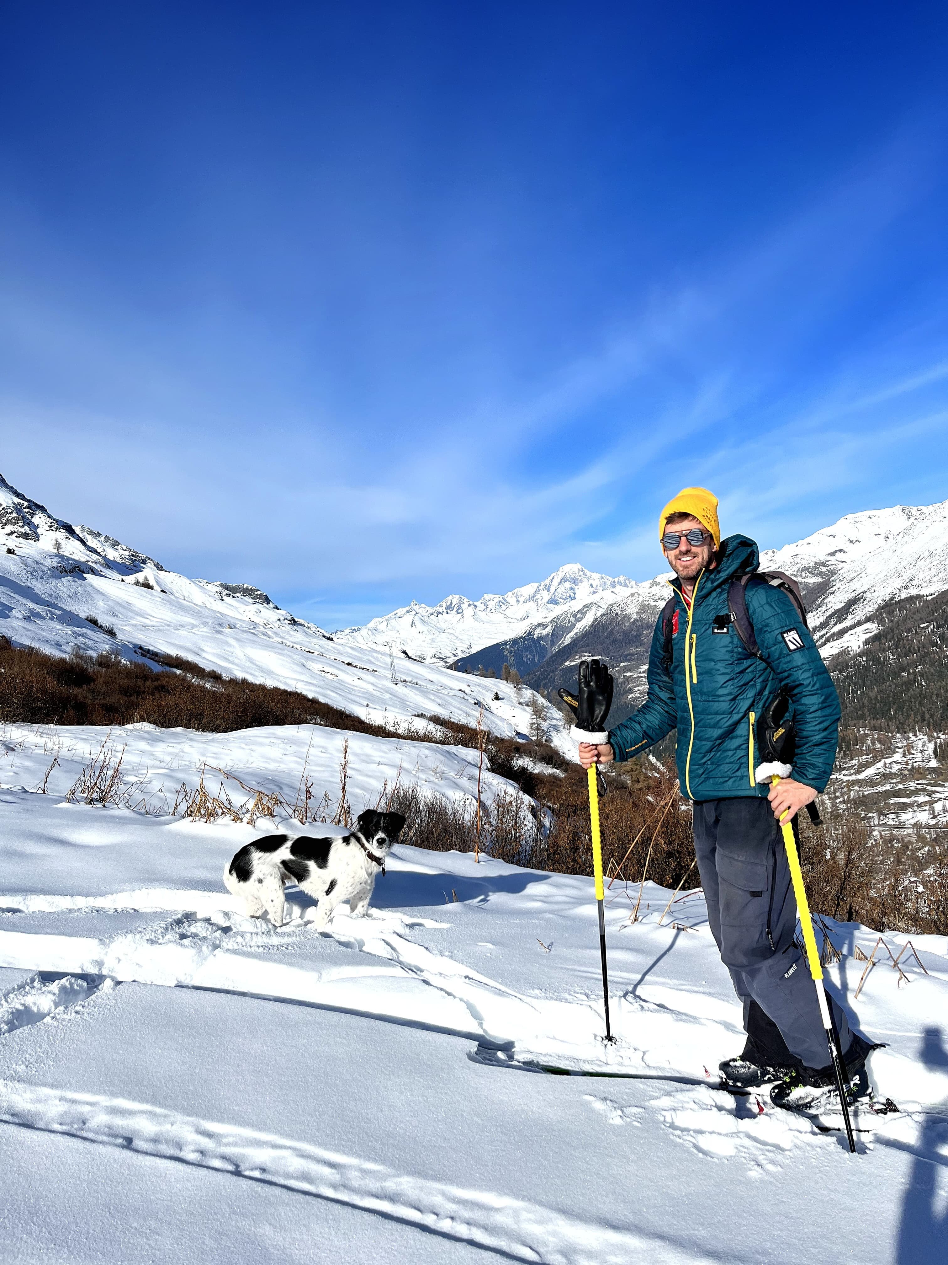 Ski instructor Terry ski touring with black and white dog
