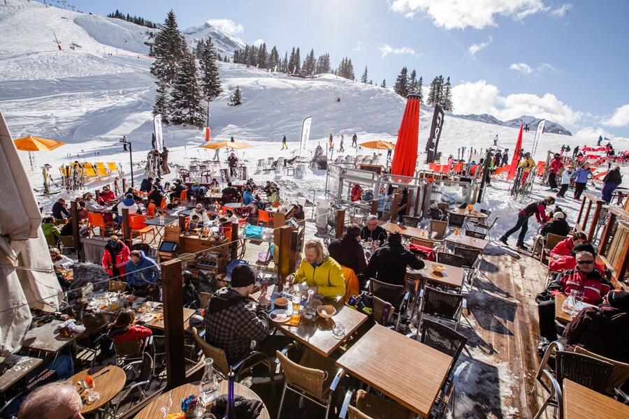 Busy outdoor terrace in Avoriaz with views of ski slopes