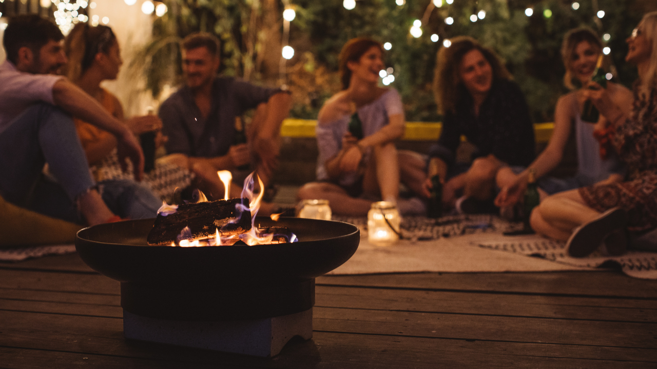 Friends sitting around firepit in the evening