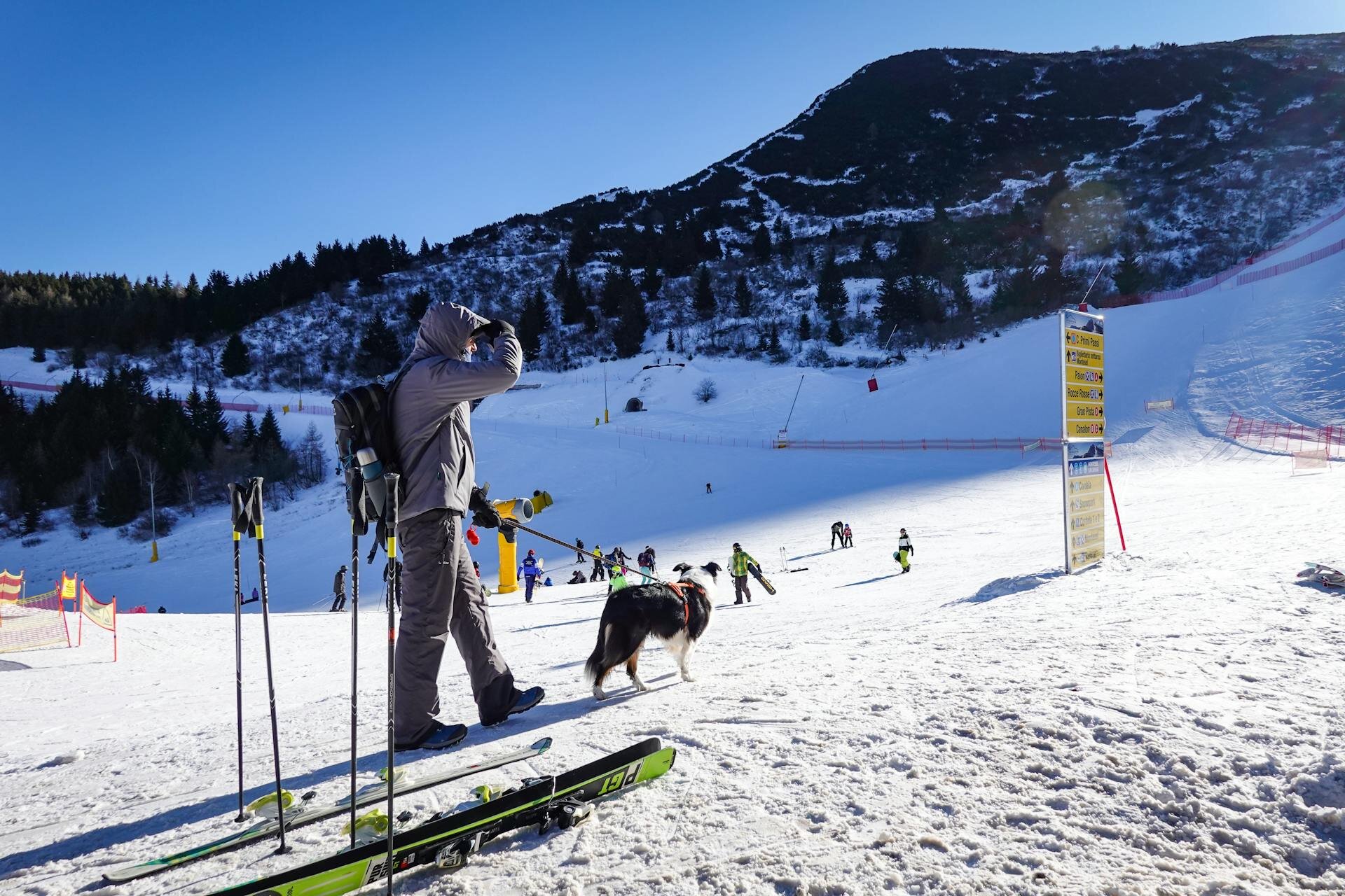 man with dog in a ski resort