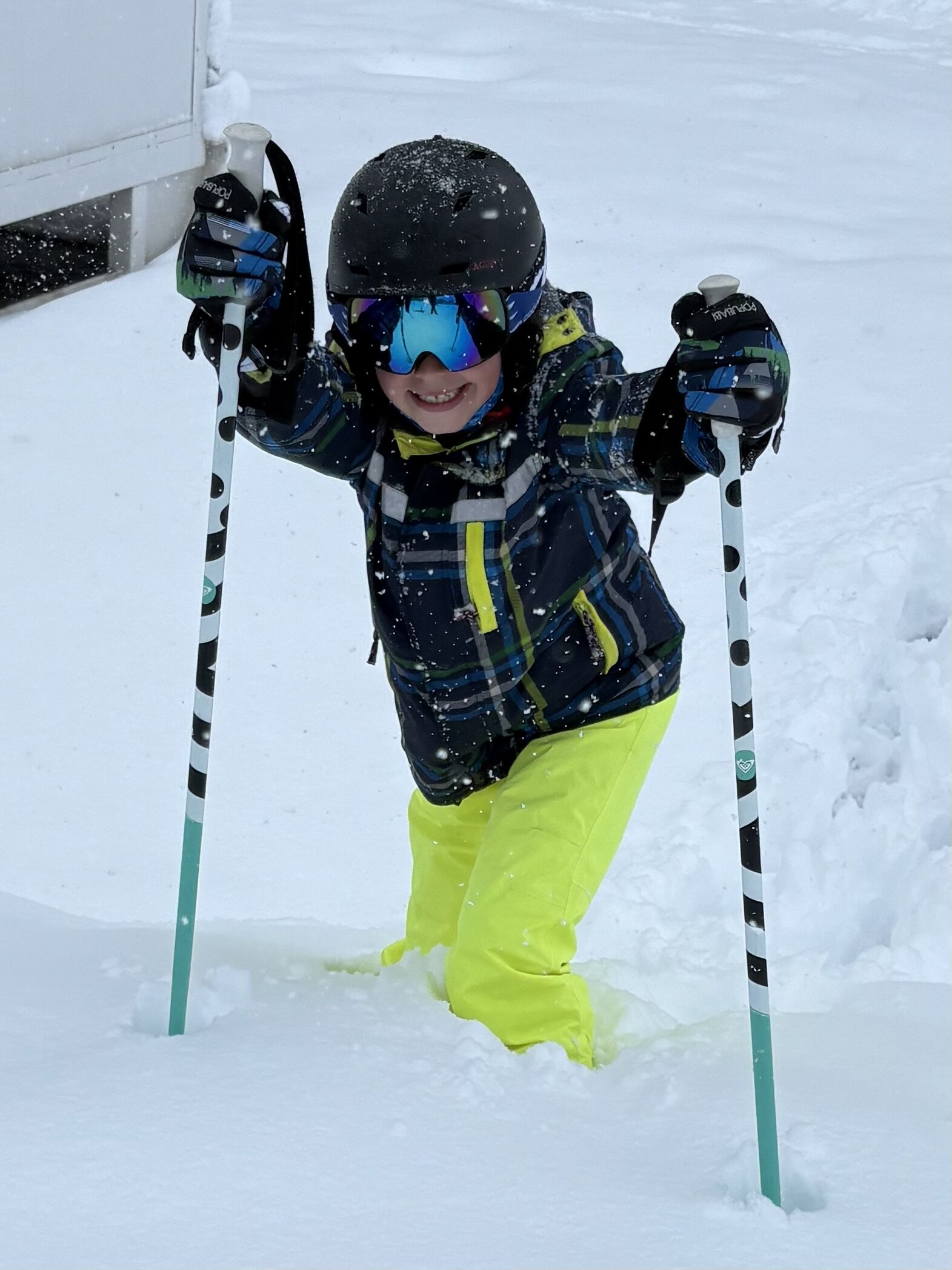 boy wading through deep snow