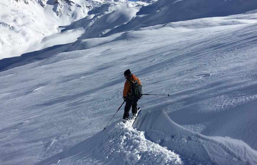 Skier making fresh tracks on off-piste slope
