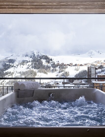 Bubbling hot tub with mountain views at K2 chalet in La Plagne
