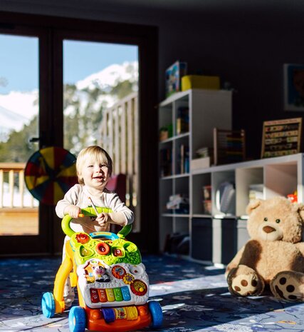 Toddler playing with toy in Bear Cubs playroom