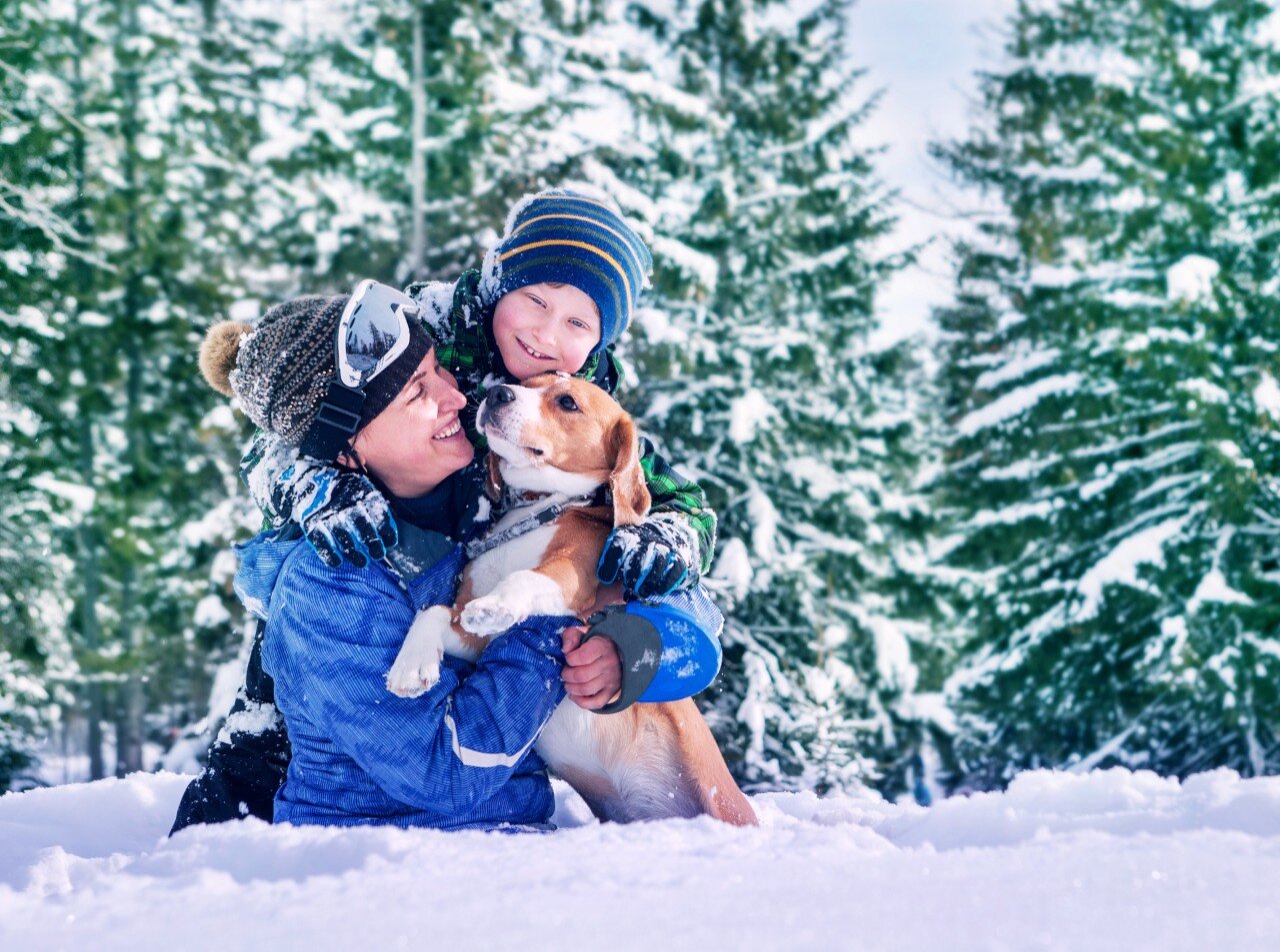 lady and boy in a ski resort with their dog
