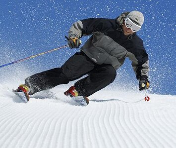 man skiing with carving skis
