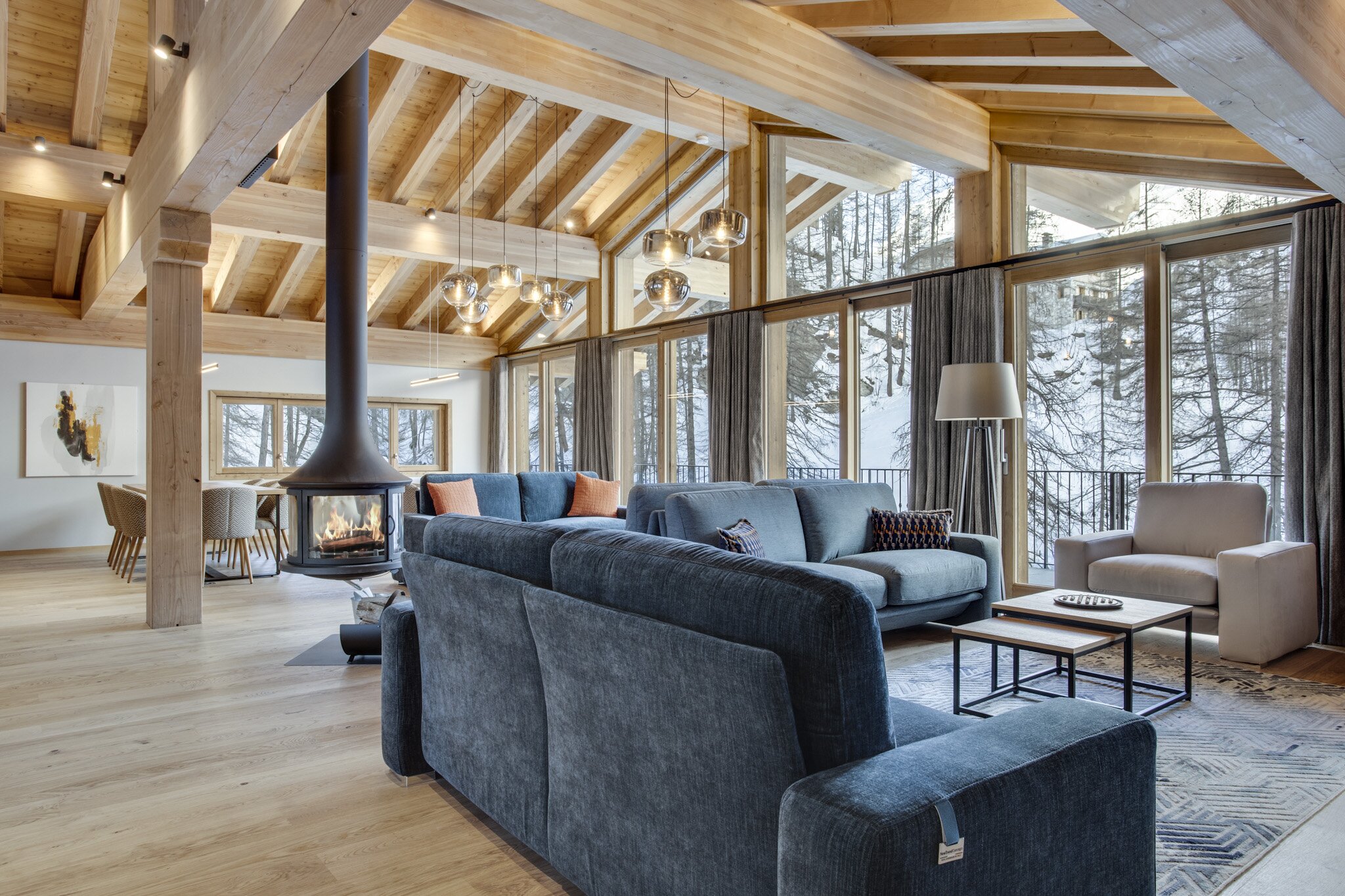 Contemporary living area with sofa and tiled floors and woodburning stove in No 7 CLUB Bellevarde in Val d'Isere