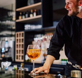 Barman at Bear Lodge serving cocktail