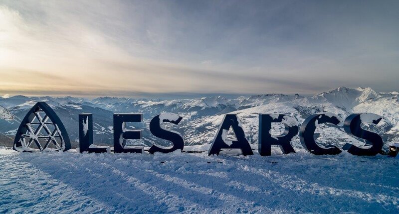 Les Arcs sign, large letters spelling the ski resort with snow covering
