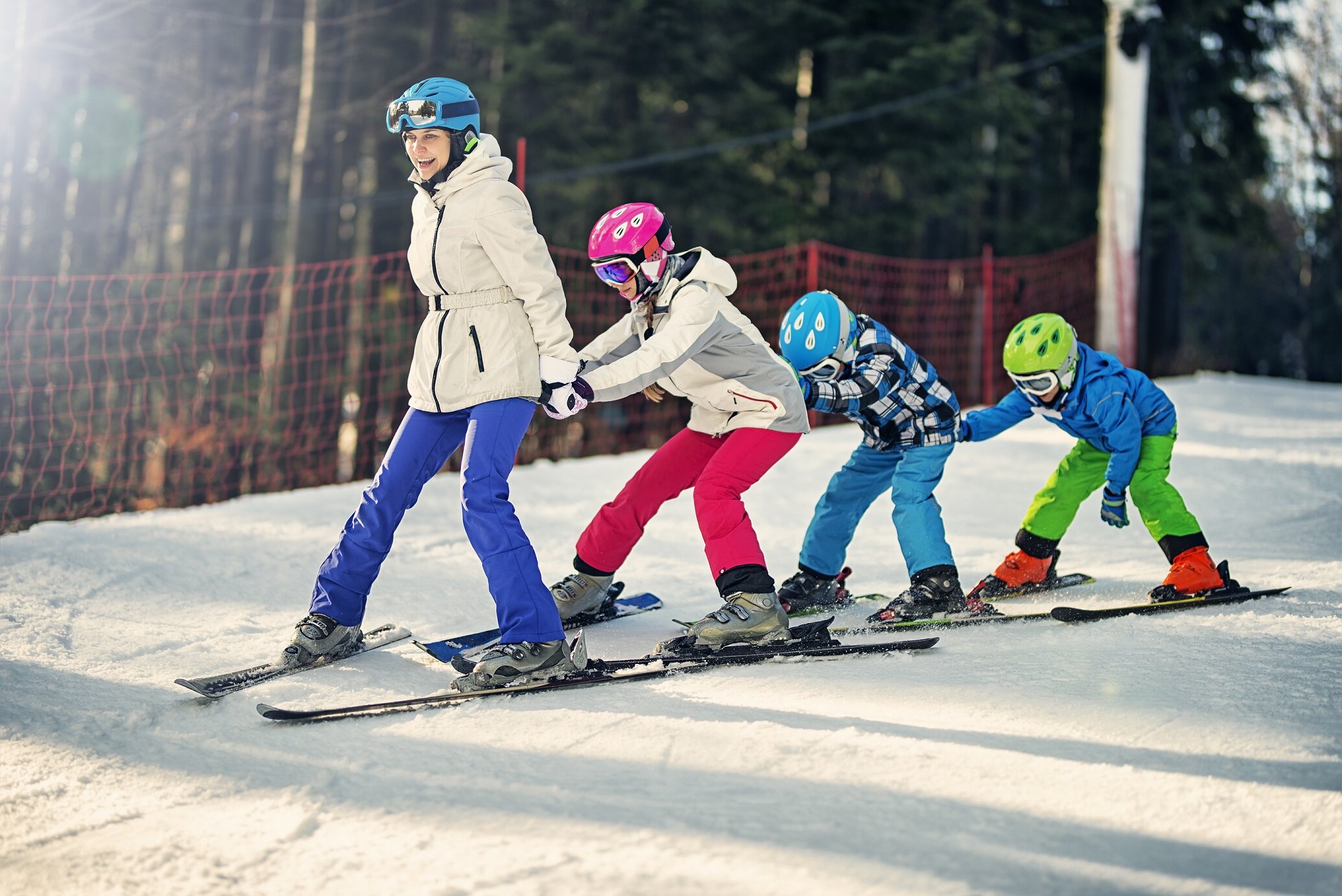Mum and three children skiing