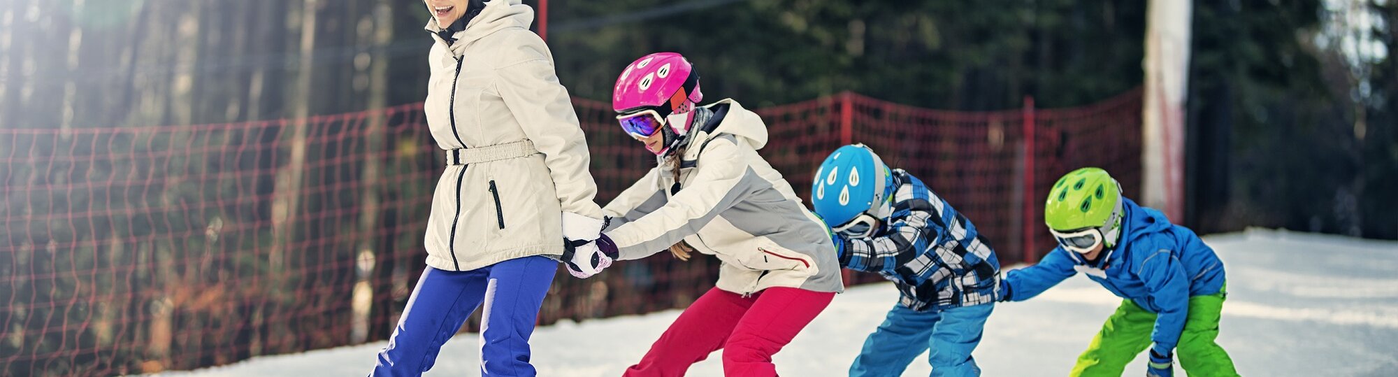 Mum and three children skiing