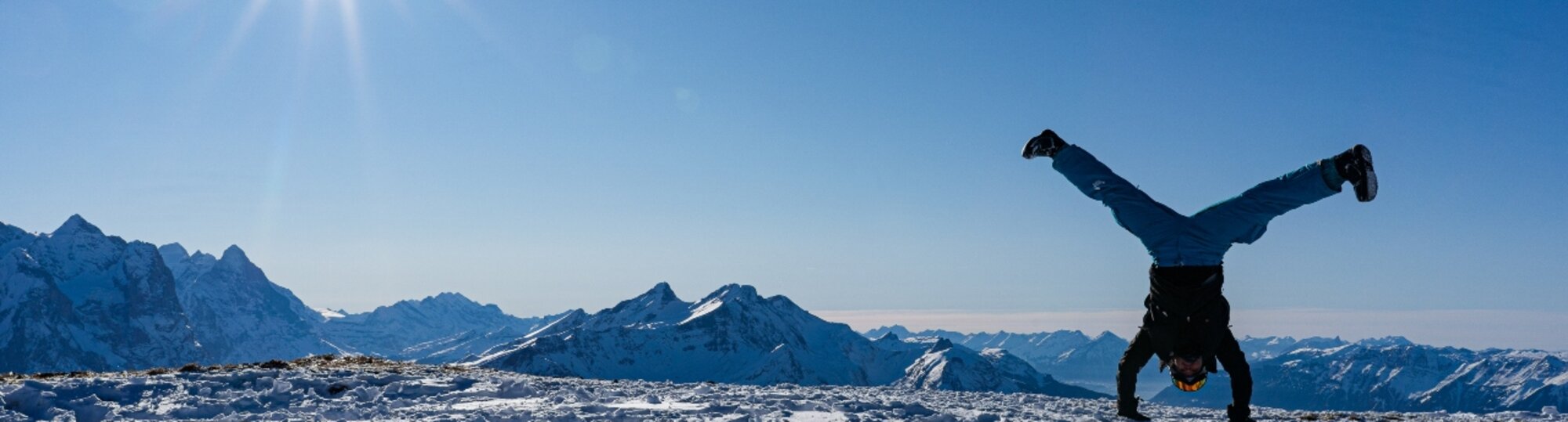 Person cartwheeling in the snowy mountains